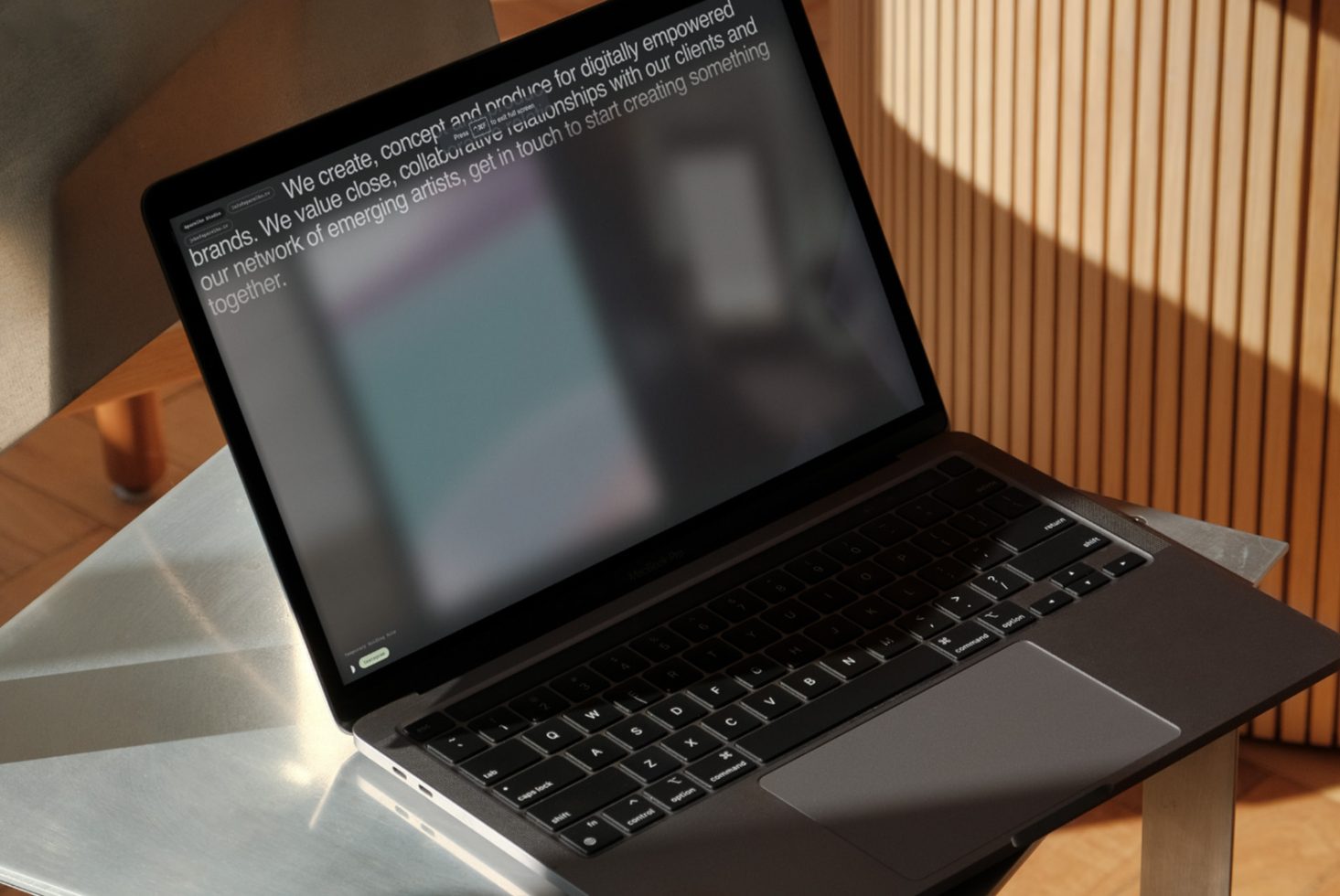 Laptop on desk with text on screen, modern workspace mockup, professional design tool, digital asset for template creation.